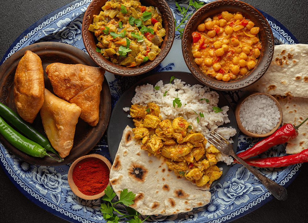 A collage of mouthwatering dishes from various international Indian restaurants, including butter chicken, tandoori chicken, and dosa.